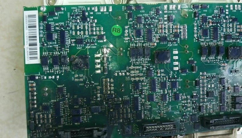 Gate driver control board from a central solar inverter showing burn discolouration and thermal damage on the PCB surface adjacent to the IGBT failure point