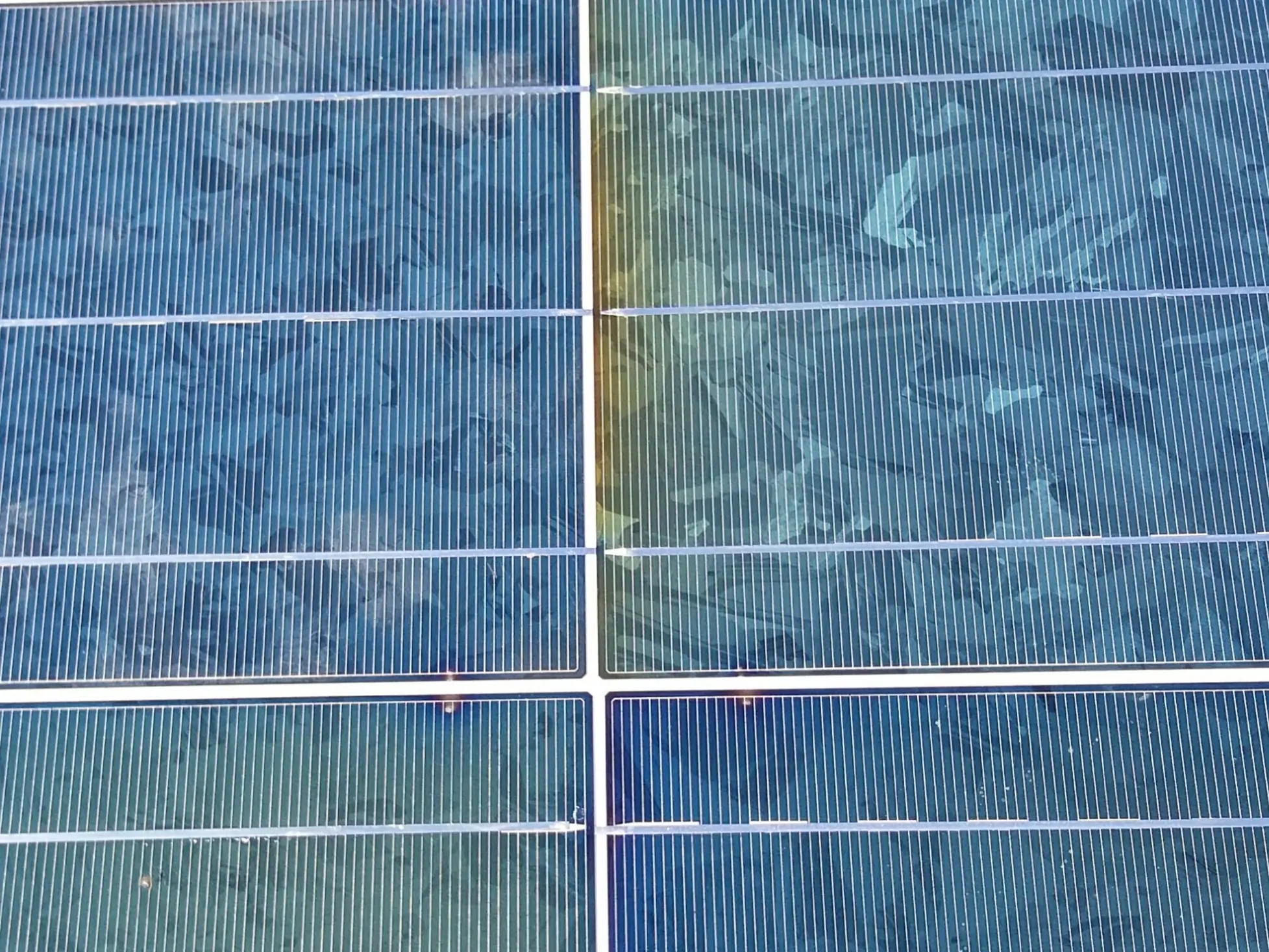 Advanced encapsulant delamination and bubbling on a solar panel caused by repeated hotspot thermal stress — visible yellowing and moisture ingress indicate irreversible module damage